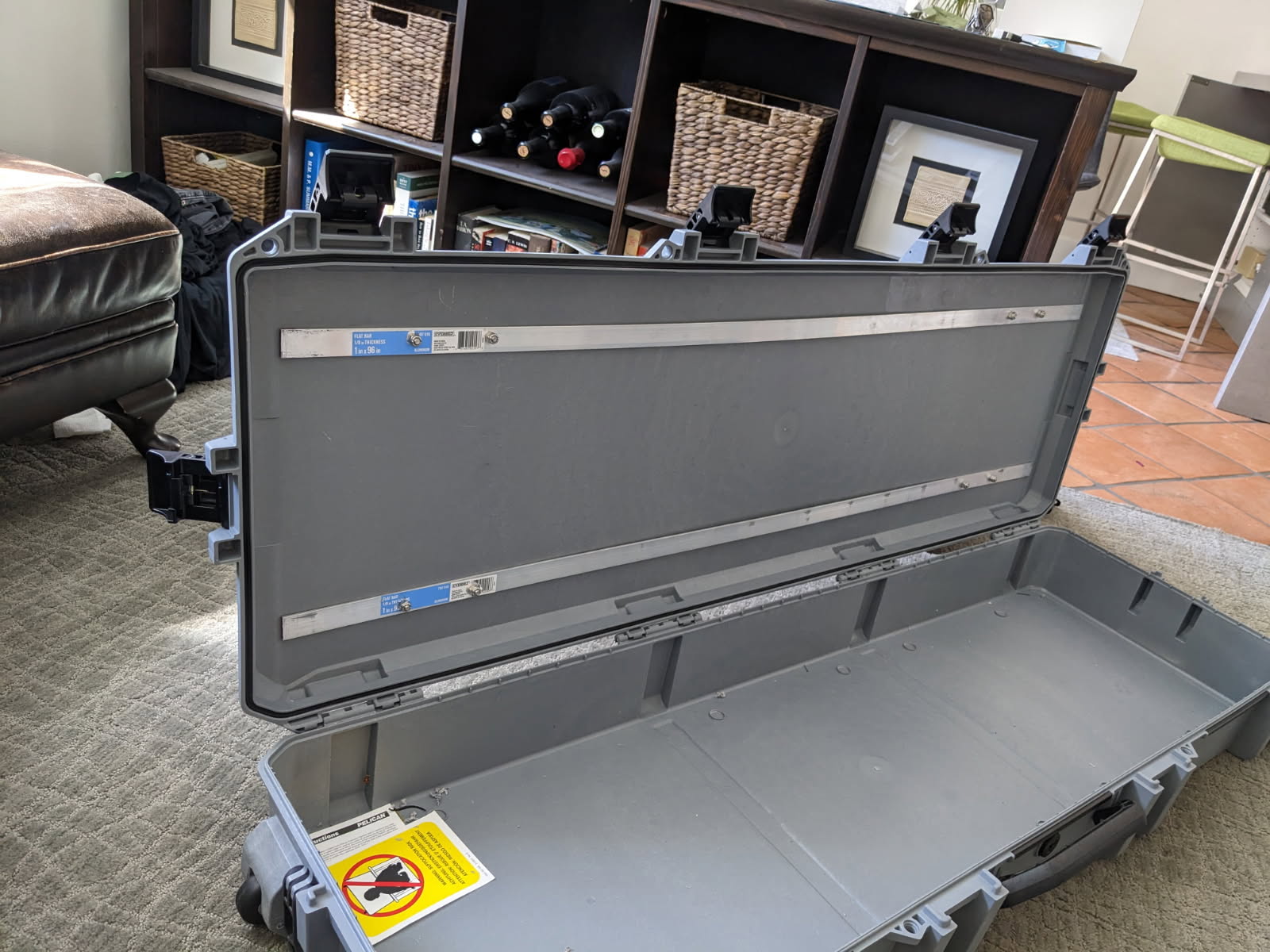 Aluminum flat bar backing plates bolted inside the Pelican V800 lid